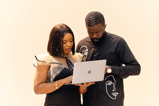 Two colleagues working together on a laptop